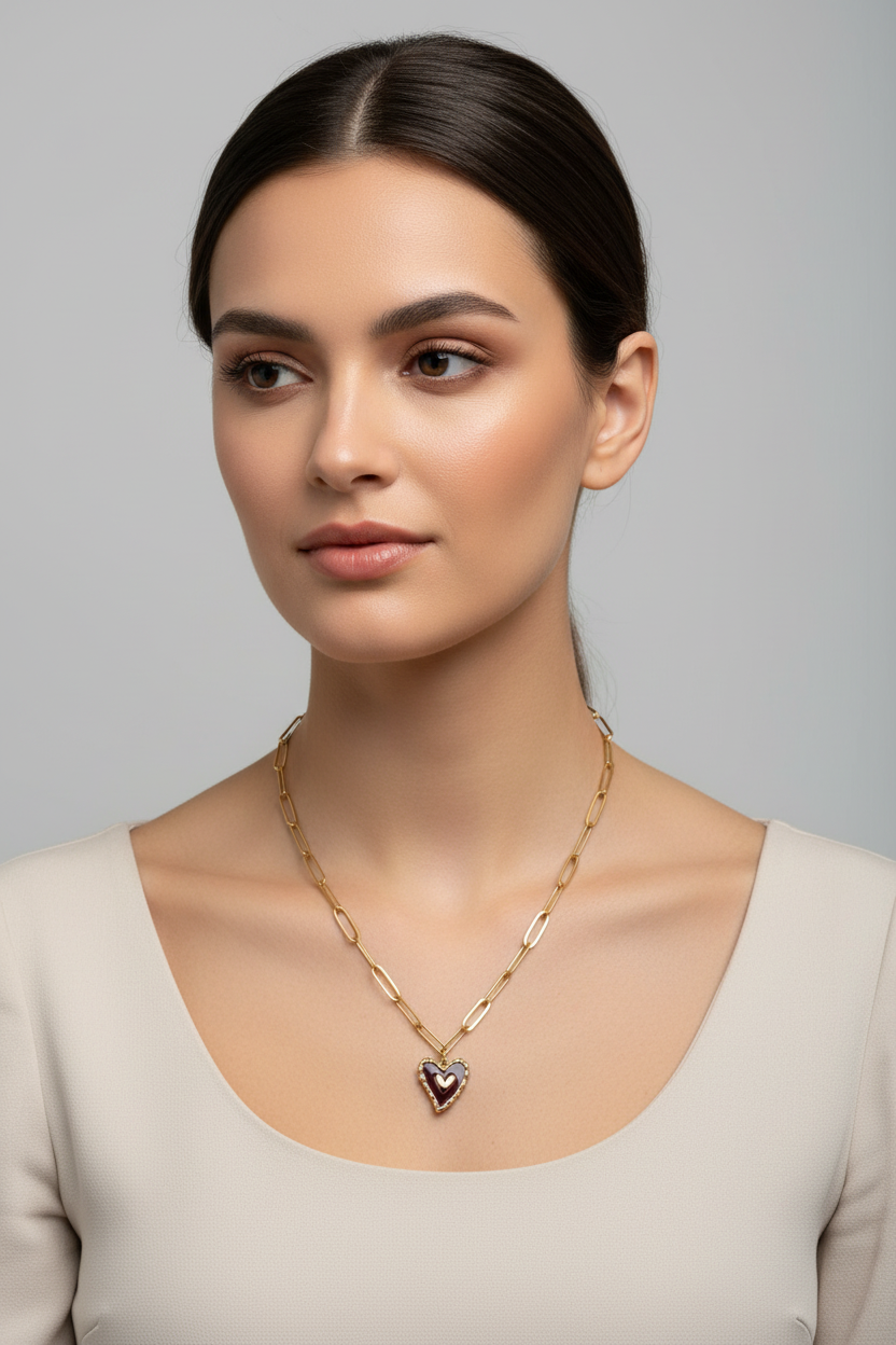 Gold chain necklace with a heart pendant on a model