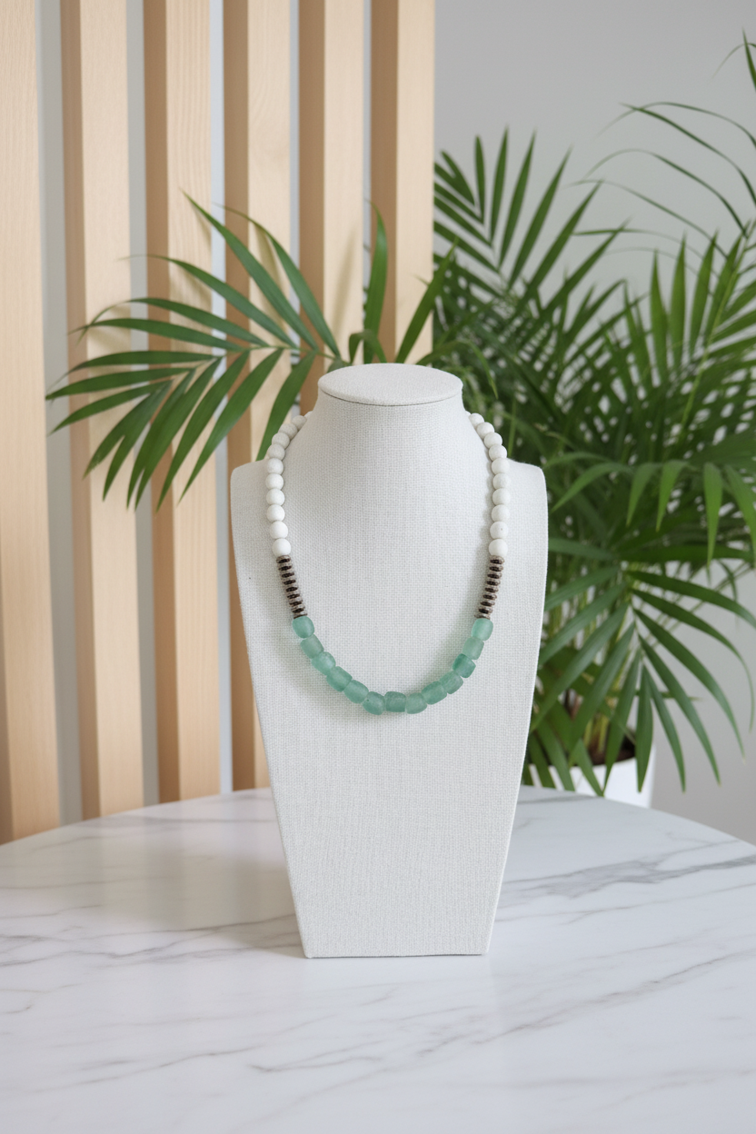 African Glass Beaded Necklace on a bust with a white countertop and slated wood background