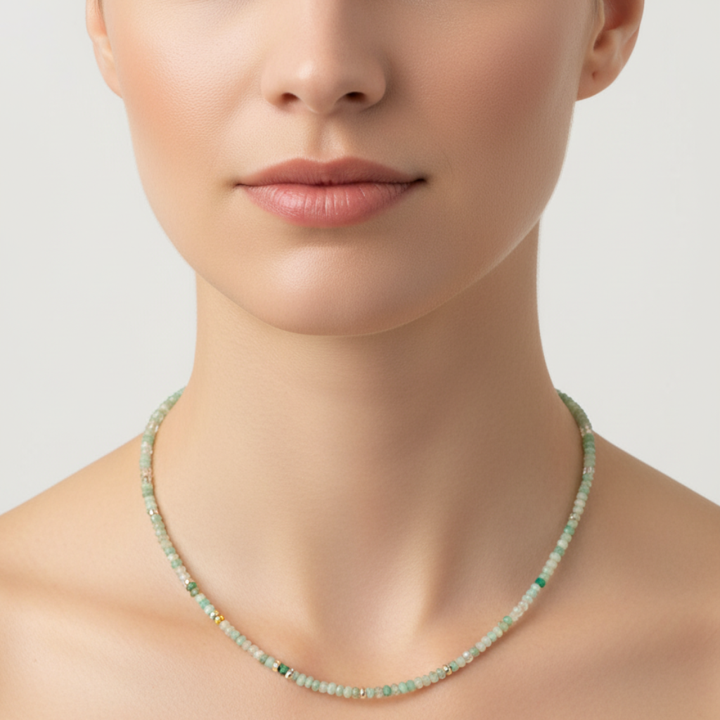 Necklace with green beads worn by a model on a neutral background