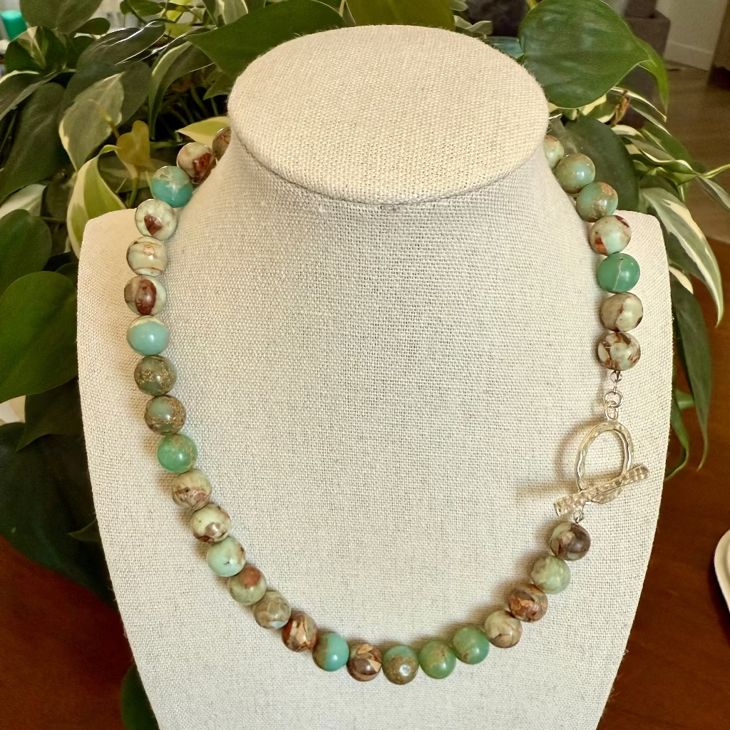 Multi colored gemstone neckace on linen bust