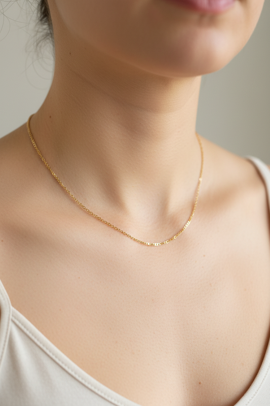 Gold curb chain necklace on a model