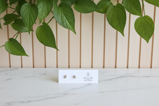 Dendritic Opal Earrings on a 'Willow & Fern' card on a white counter with a leafy background