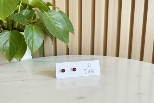 Garnet earrings on a Willow & Fern earring card sitting on a white counter with a plant in the background