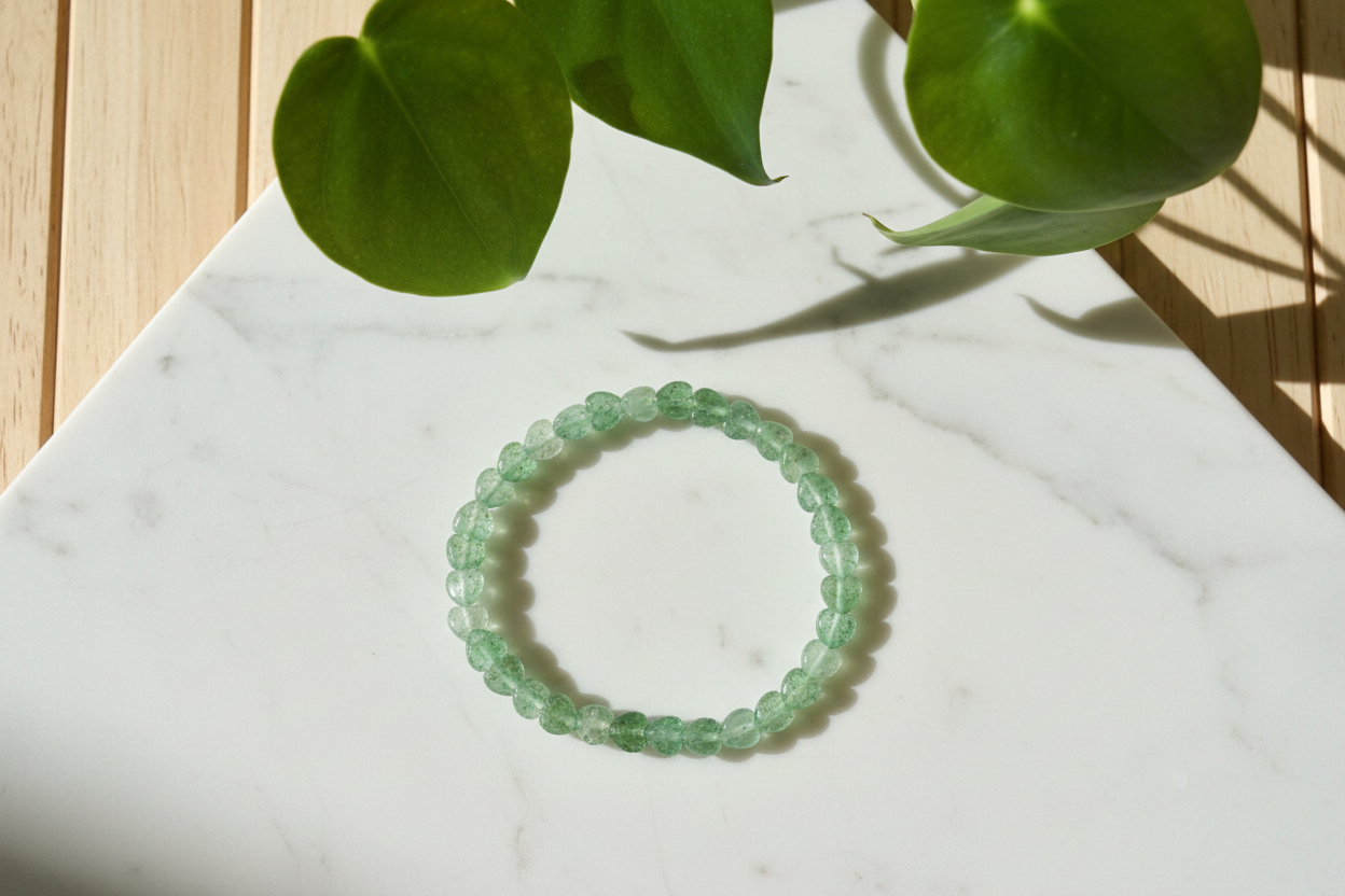 Green beaded bracelet on a white countertop