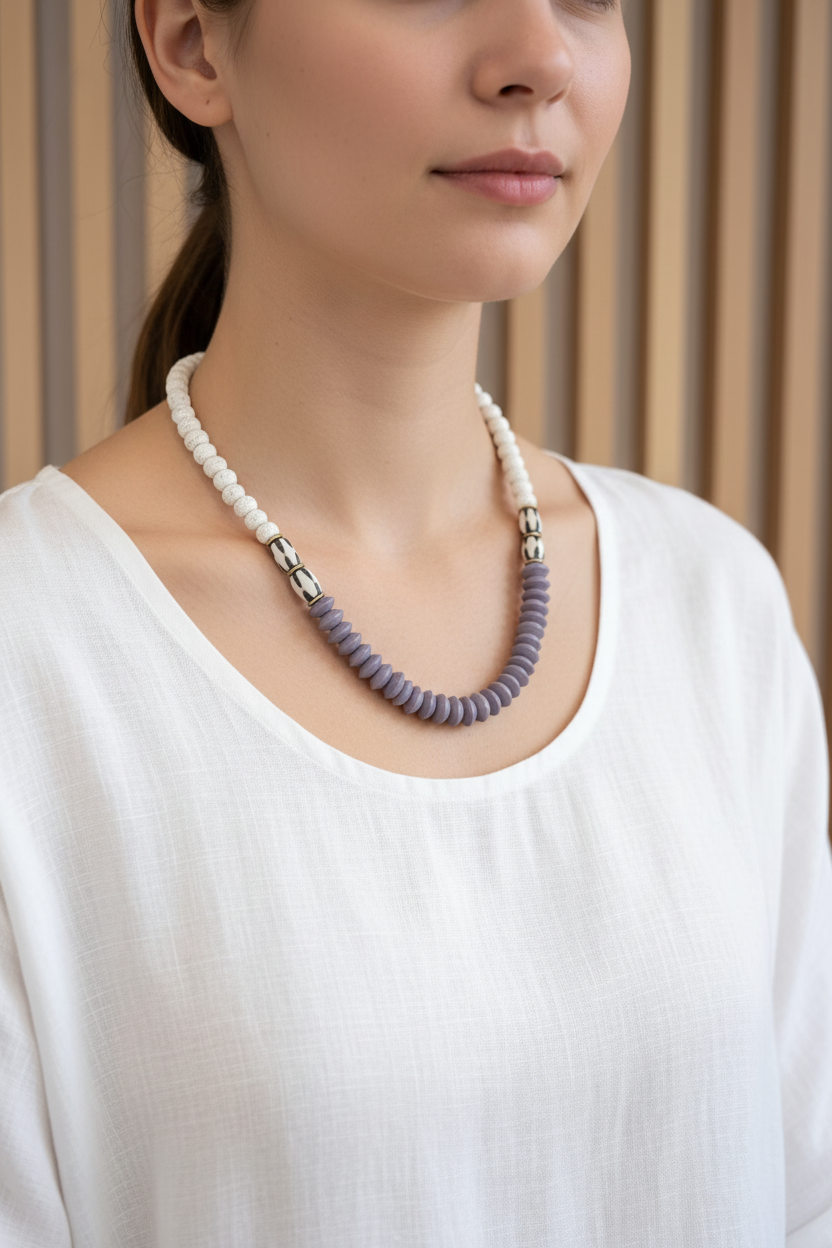 A mixed purple beaded necklace on a model