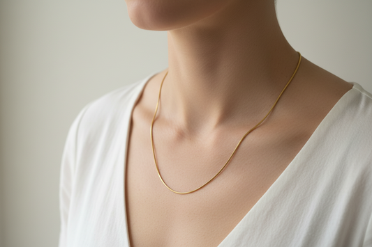 Gold snake chain necklace on a model