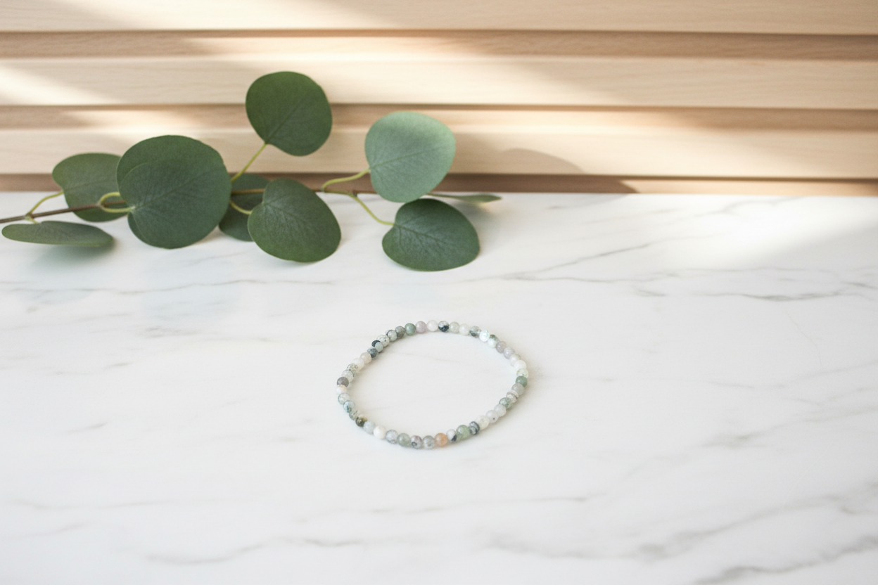 Beaded bracelet on a white counter with a plant in the background