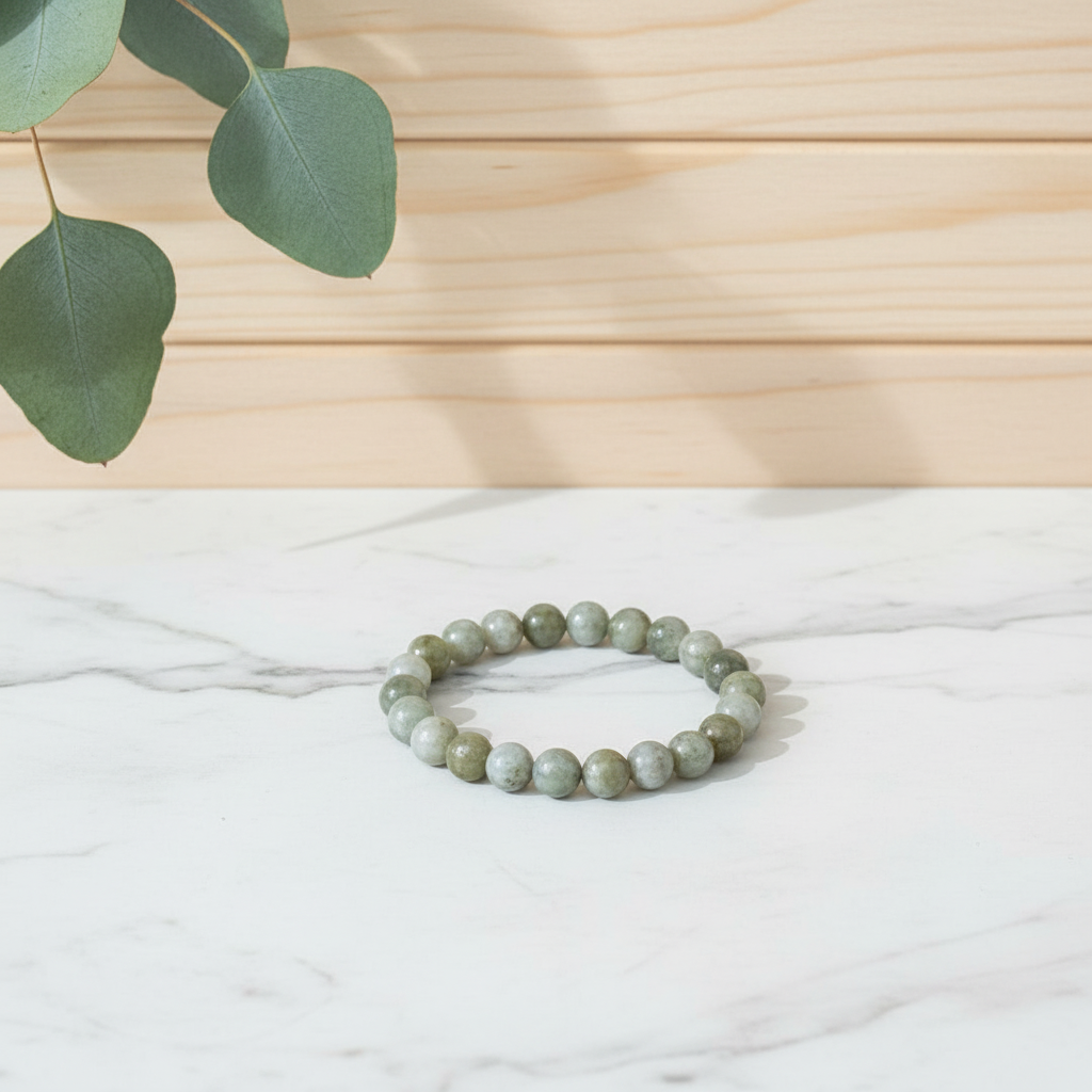 Green Jade Bracelet on a white counter with a wooden background