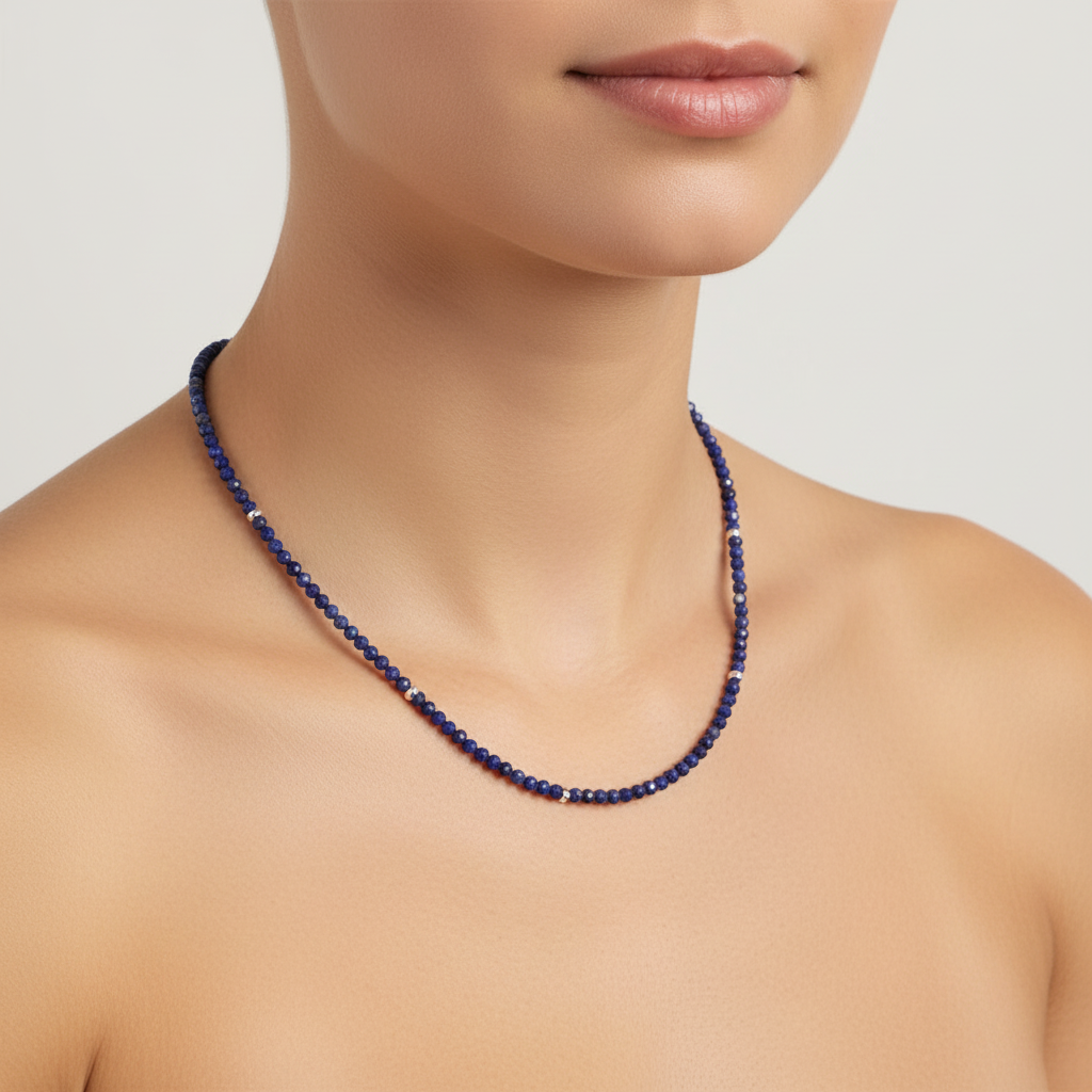 Blue beaded necklace on a model with a neutral background