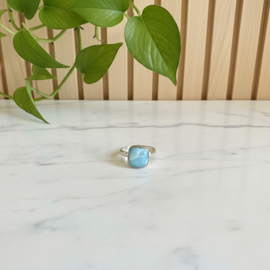 Sterling Silver and Larimar Ring on a white counter with a plant behind