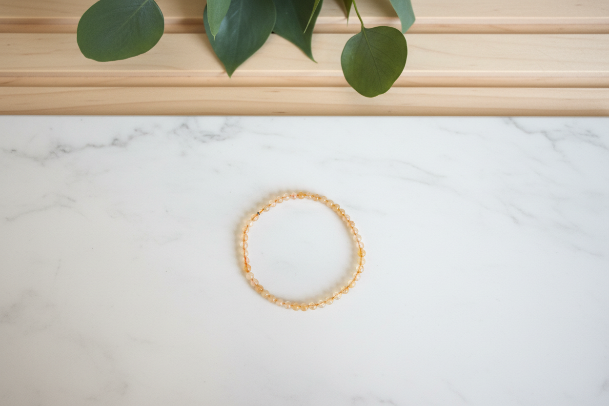 Citrine bracelet on a white counter with a plant on the background