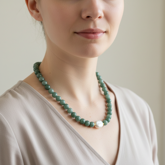 Green jade beaded necklace with a large pearl on a model